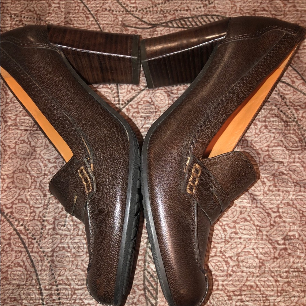 Brown leather heeled loafers.